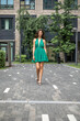 © Andrey_Arkusha - Young beautiful brunette woman in a green polka dot dress