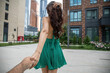 © Andrey_Arkusha - Follow me. Young woman holding a mans hand. Travel with me