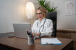 © Nenad - Female doctor working on her laptop pc