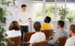 © JackF - European man leads a lecture in the audience during a meeting of men gays