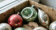 © Andrey - Old worn glass Christmas ornaments in cardboard box