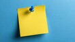 © mila103 - A bright yellow sticky note is fastened with a blue push pin to a smooth blue surface, providing a simple yet effective reminder tool for notes and messages.