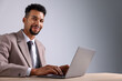 © New Africa - African-american man using laptop at wooden table