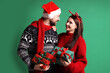 © New Africa - Happy couple with Christmas gifts on green background