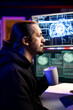 © DC Studio - Rogue programmer holding coffee mug uses AI deep learning to develop zero day exploit undetectable by antivirus. Hacker drinking beverage uses artificial intelligence to build script doing data mining