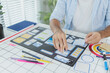 © PHOTO4U - A male designer focused on UX UI tasks, creating app prototypes with wireframes, sketches, and color palettes. He works with creative ideas to optimize user interface and usability.