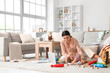 © Pixel-Shot - Young business mother working with laptop and cute little baby playing in living room