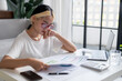 © Charlie's - Asian Woman Managing Finances pay Bills and Budget financial at home.
