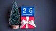 © Ansar - December twenty five date display with mini christmas tree and gift box