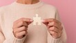 © Yuparet - Person’s hand, team conflict, emotional stress, Hopeful Woman Holding Broken Puzzle Piece Symbolizing Failed Connection in Collaboration with Emotional Expression in Soft Light and Pastel Tones