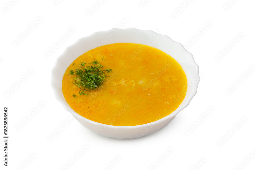 Yellow lentil soup topped with fresh herbs in a white bowl