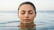 © adaptable_ Lark98A1 - A serene woman with closed eyes emerges from calm water, embodying tranquility and relaxation.