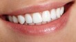 © ittipol - A close-up of a bright, healthy smile showcasing perfect white teeth. The image conveys confidence, happiness, and the importance of dental care in personal grooming.