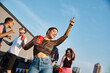 © Bliss - Fun filled rooftop celebration with young friends enjoying the sunset together