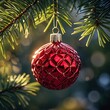 © Degita - Capture the magic of the holidays with this festive red Christmas ornament hanging on a lush green pine tree, perfect for seasonal cheer
