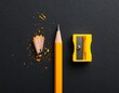 © cangkir - Sharpened pencil and sharpener on dark background