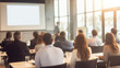 © vStock - Modern business seminar with audience listening to speaker in bright conference room, corporate training and networking