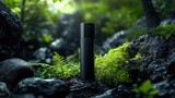Elegant black bottle mockup showcased amidst lush greenery and natural stones