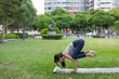 © leungchopan - Woman practicing crow pose yoga exercise at city park