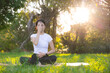 © leungchopan - Woman practicing pranayama breathing exercises at park