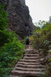 © Xalanx - Hiker climbing stone steps canyon
