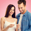 © vgstudio - Love, relationship, new parents and happy family concept - joyful young cute couple, husband, wife finding out results of pregnancy test, isolated against vivid rose pink background. Square image