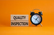 © Natallia - Quality Inspection symbol. Concept word Quality Inspection on wooden blocks. Beautiful orange background with alarm clock. Business and Quality Inspection concept. Copy space