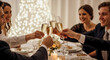 © Angavlan - People toasting with champagne at festive dinner, glasses raised in celebration. People toasting and sharing joy around festive dining table with elegant floral centerpiece.