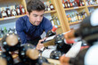 © auremar - man choosing bottle of wine in shop