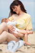© auremar - mother breastfeeding baby on the beach