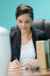 © auremar - young business woman doing paperwork in the office