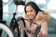 © auremar - happy woman using a padlock on her bike