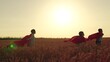 © Victoriia - Kids in cape play heroes. Happy children run play superheroes in nature. Children boy girl play superhero in red cape on wheat field, children dream. Child hero in red cape run into sunset. Carnival
