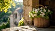 © Somad - A woven basket filled with white flowers sits on a stone ledge in front of a stone wall. A village is visible in the background, bathed in sunlight.