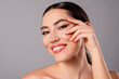 © Beauty Hero - Close up of a beautiful young woman with glowing skin and confident expression, highlighting natural beauty