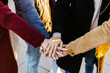 © Xavier Lorenzo - Friends dressed in winter clothing, joining hands in a display of teamwork and unity, embodying support and connection in the outdoors