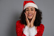 © New Africa - Beautiful woman in Mrs Claus costume on gray background. Christmas season