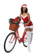 © New Africa - Beautiful woman in Mrs Claus costume with bicycle and Christmas gifts on white background