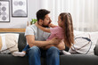 © New Africa - Emotional father hugging his daughter on sofa at home. Family bonding