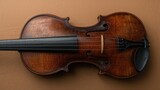 A violin with a bow on a brown background. Classical musical instrument, string instrument, and musical performance.