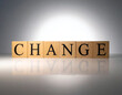 © fara - The word CHANGE spelled by wooden blocks on a reflective surface, illustrating concepts of transformation, evolution, and opportunity.
