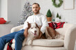 © Pixel-Shot - Handsome young man with cute Husky dog at home