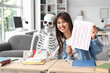 © Pixel-Shot - Female student with answer sheet for test and human skeleton model at university