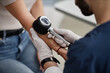 © Seventyfour - Woman undergoing skin examination by male dermatologist using dermatoscope on forearm, medical professional wearing gloves performing diagnostic procedure