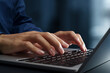 © tadamichi - Businessperson using laptop computer at desk in office. Closeup of hands and keyboard. Business technologies.
