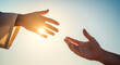 © Cliff - Close-up of Jesus' hand reaching out for salvation to a man's hand, isolated on a sky background and with sunlight. Miracle of saving the life of Jesus Christ, the Son of God, salvation of the soul