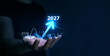 © Miha Creative - Business plan for increase in 2027 year.Development to success and motivation in new year 2027. Business person draws increase arrow graph corporate future growth year 2026 to 2027.