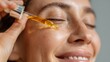 © Iaroslav - Woman applying beauty serum to her face with a dropper, moisturizing skin for healthy aging and skincare routine