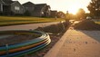 © DisignUA - Colorful fiber optic conduit cables lying near a trench in a suburban neighborhood