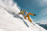 Fast man snowboarder rides in cloud of powder snow outside ski slope. Backcountry or offpiste free riding at ski resort